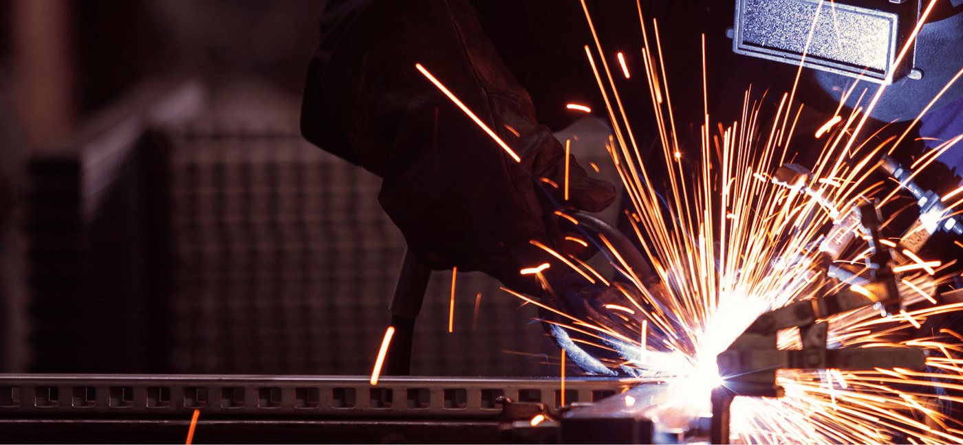 Close-up of welding process with sparks flying from metal work