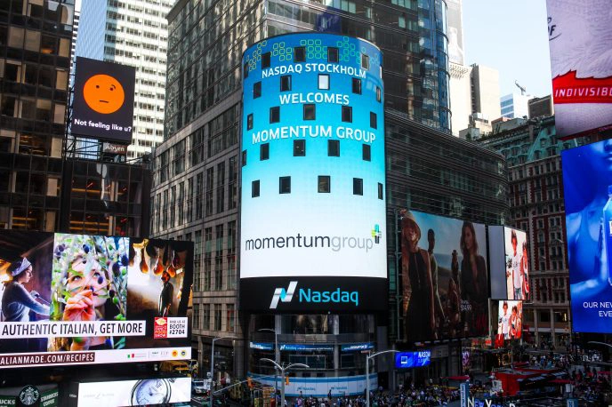 Momentum Group on a Nasdaq screen in Times Square