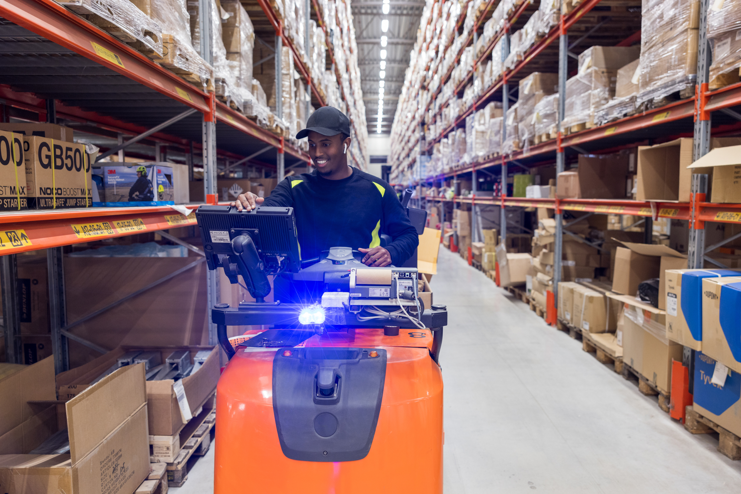 Forklift in an aisle of a high-bay warehouse