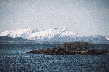Snöklädda berg vid havet